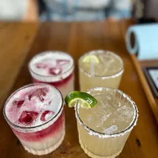 three margaritas on a wooden table