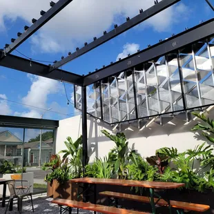 a patio with a table and benches