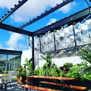 a view of a patio with tables and benches