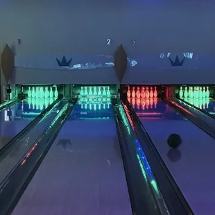 a bowling alley with bowling pins and bowling balls