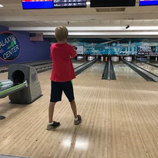 a young boy playing bowling