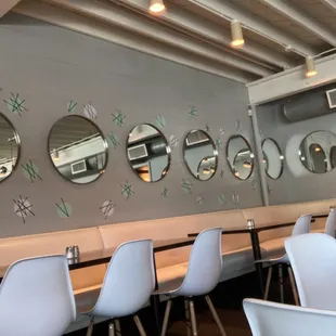 a row of chairs and mirrors