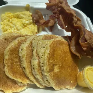 a breakfast of pancakes, eggs and bacon