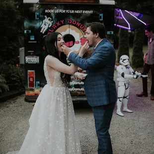 a bride and groom feeding each other