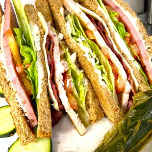 a plate of sandwiches with pickles