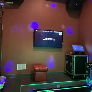 a room with a television, speakers, and a coffee table