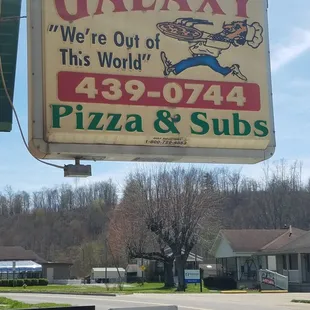a sign for galaxy pizza and subs