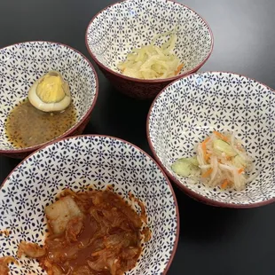 three bowls of food on a table