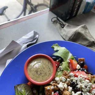 a plate of salad with dressing