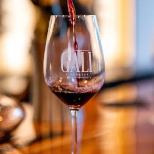 a glass of wine being poured