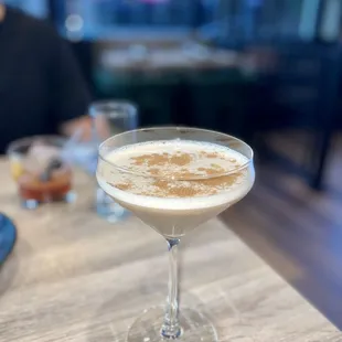 a drink in a glass on a table