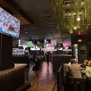 Vibe of the dining area where the taupe, round booth are... bit bright (almost Vegas neony)  from the screens, imo.