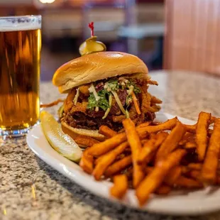 a plate of food and a glass of beer