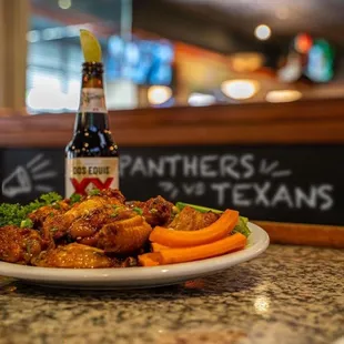 a plate of food and a bottle of beer