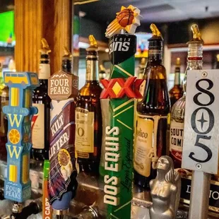 a row of beer taps on a bar