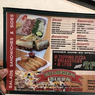 a hand holding a menu