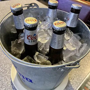 a bucket full of beer bottles