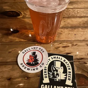 a pint of beer and a sticker