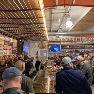a large group of people sitting at a bar