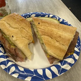 Cuban sandwich with Mojo pork, cheddar cheese, and pickles.