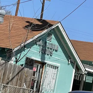 a blue building with a brown roof