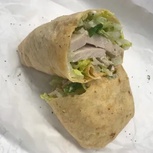 Carved turkey in a sun-dried tomato wrap.