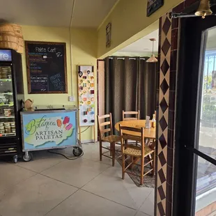 Inside the front door, one of two tables in front.