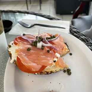 Lox cream cheese tomato red onion capers on an everything bagel
