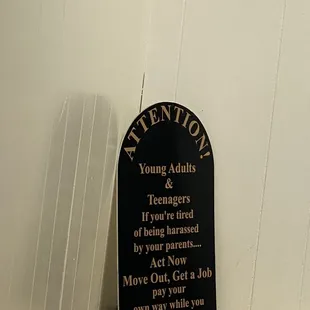 a sign on a toilet in a restroom