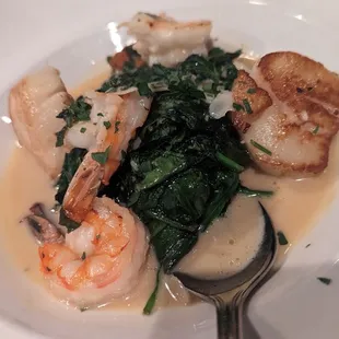 Shrimp and Scallops with sautéed spinach.
