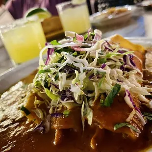 New Mexican Enchiladas Especial...delicious! Don&apos;t forget to take advantage of the Happy Hour Margaritas (pictured in the back)!