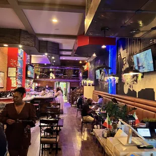 people sitting at tables in a restaurant