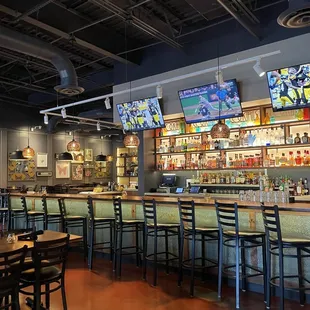 a bar with multiple televisions