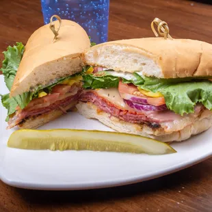 a sandwich and pickle on a plate