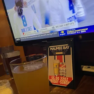 a glass of beer and a television