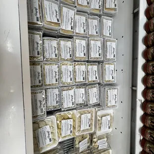 a shelf full of cheeses