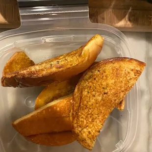 Hamburger bun cut in half and sold as garlic bread