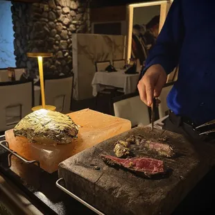 Gold leaf wrapped steak. I forget which cut. They finish the cook off at your table