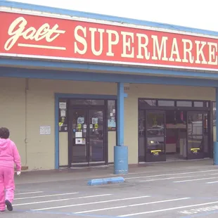 a woman walking in front of the store