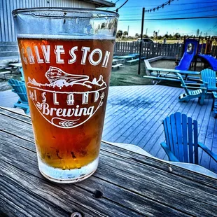 a pint of beer on a wooden table