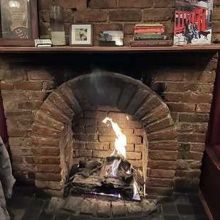 a fire in a brick fireplace
