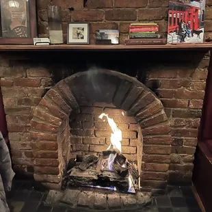 a fire in a brick fireplace
