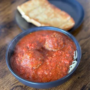 a bowl of spaghetti and meatballs