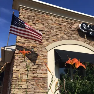 an american flag on the front of a restaurant
