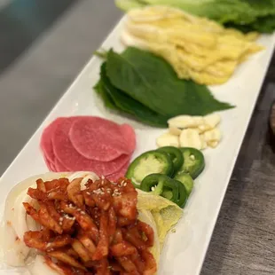 a long white plate with a variety of food on it
