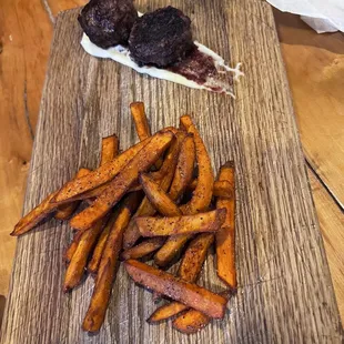 This was an elk and kangaroo meatball. The spread underneath was incredible! The side was sweet potato fries.