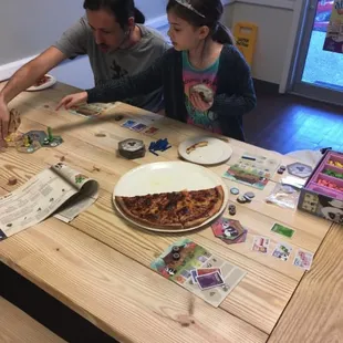 a man and a little girl sitting at a table