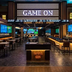 a bar with a large screen in the background