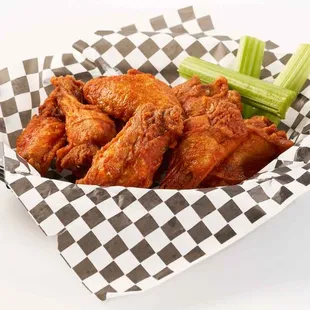 a basket of chicken wings and celery