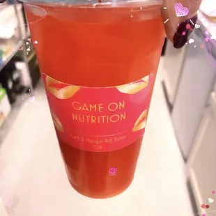 a person holding a cup of juice